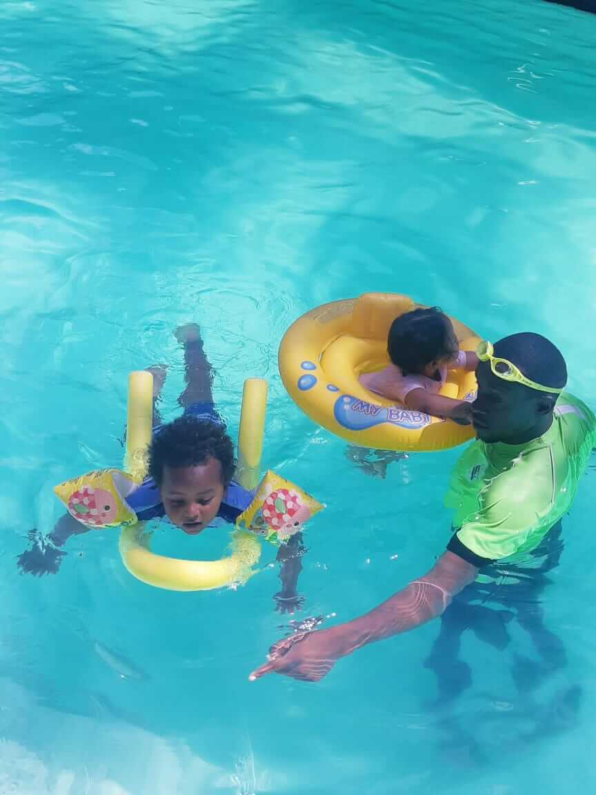 Kids practicing freestyle stroke in a lane